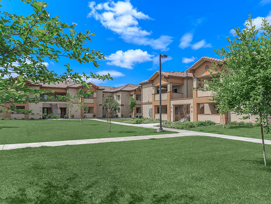 Grassy area with apartment buildings in the background